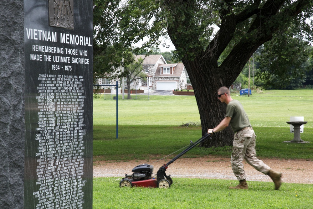 Marine mows grass at memorial