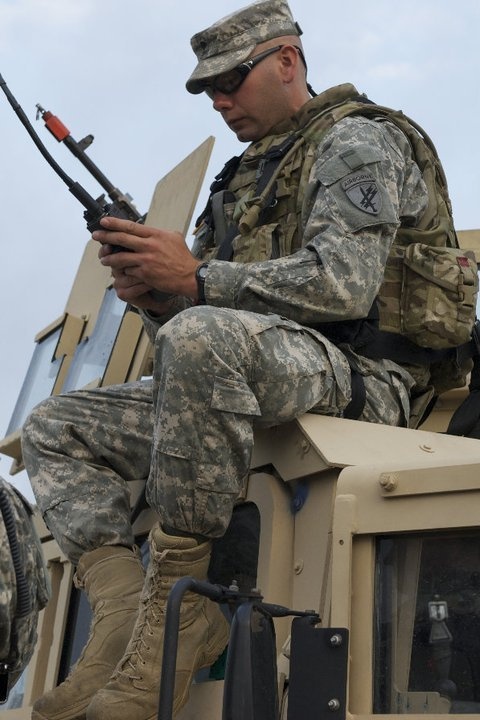 Soldier does equipment check before mission