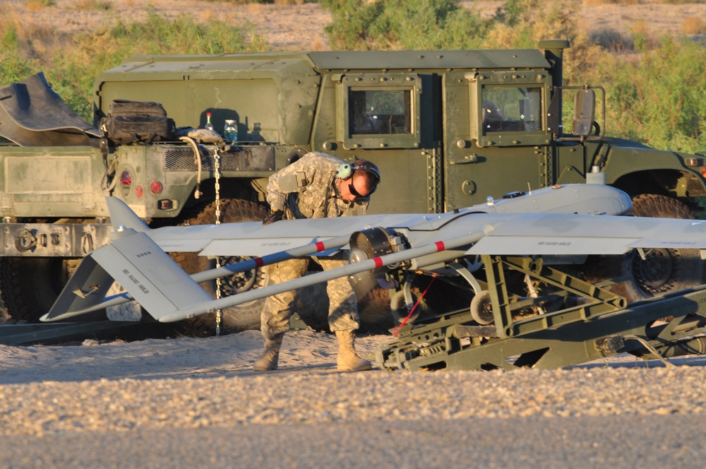 An unmanned aerial system maintainer inspects a Shadow before launch