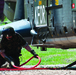 Swiss loadmaster attaches swing load cable to helicopter