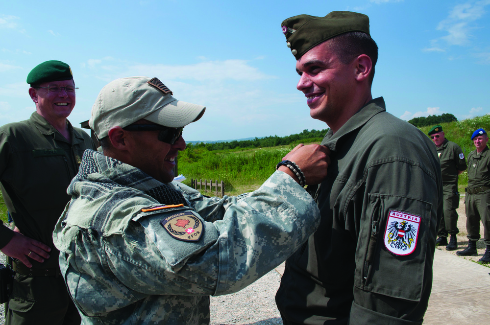 US soldier pins marksmanship badge on Austrian soldier