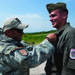 US soldier pins marksmanship badge on Austrian soldier