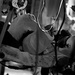 A black and white photograph showing what appears to be a medical evacuation or casualty transport scenario, likely inside a military helicopter or aircraft. A person is lying on a litter/stretcher and appears to be receiving medical care, with visible medical tubing and equipment. The image is rotated or taken at an unusual angle, and motion blur suggests the vehicle is in transit.