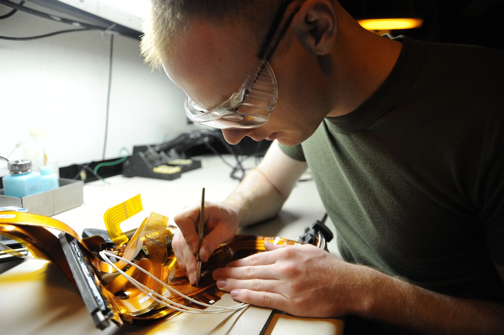 USS Enterprise sailor repairs a flex print assembly