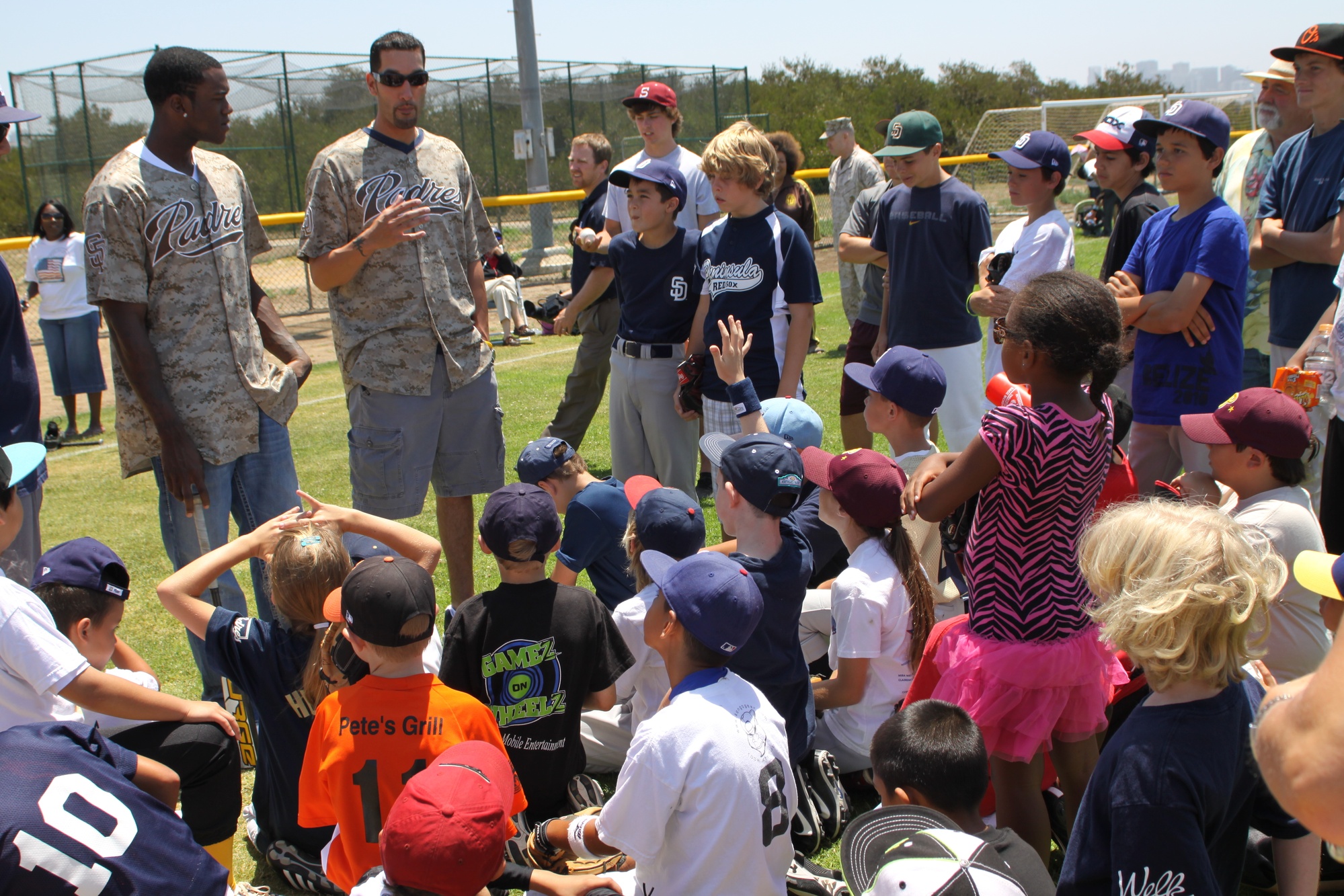 San Diego Padres center fielder Mike Cameron autographs a young