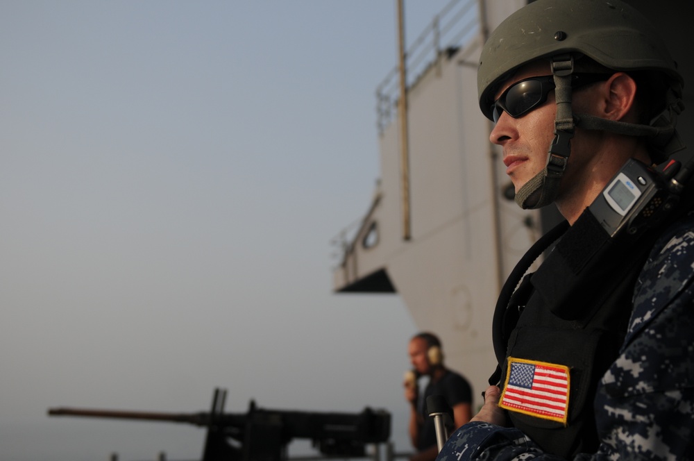 USS George H.W. Bush sailor stands on the fantail