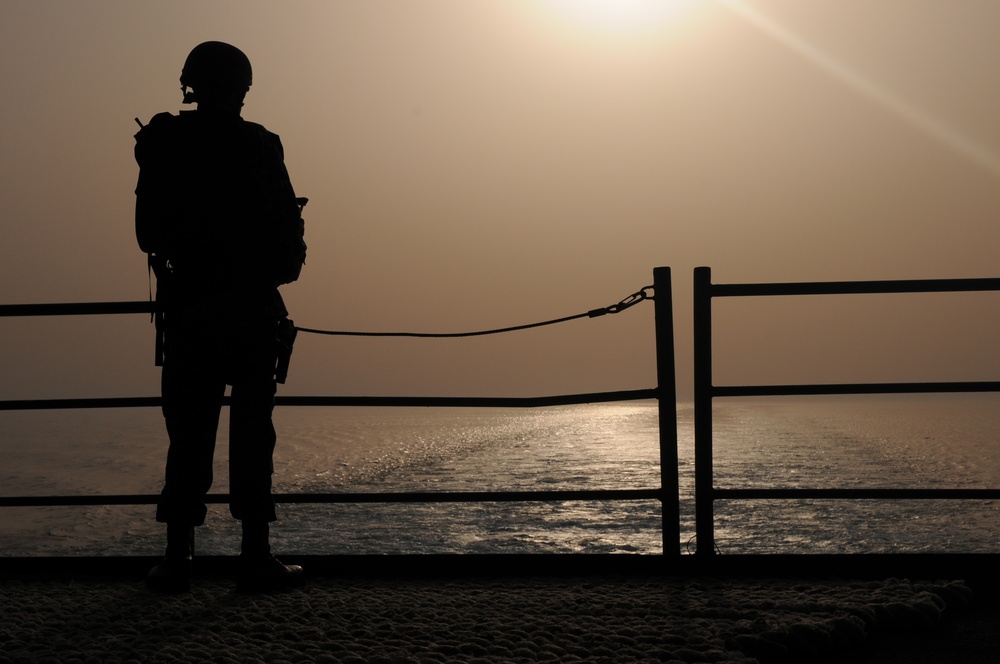 USS George H.W. Bush sailor stands on the fantail