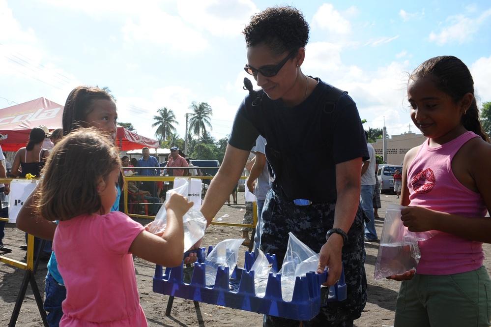 Sailor gives Guataemalan children water outside medical site