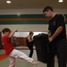 Wax on, wax off: Karate students learn martial arts during energized practice session