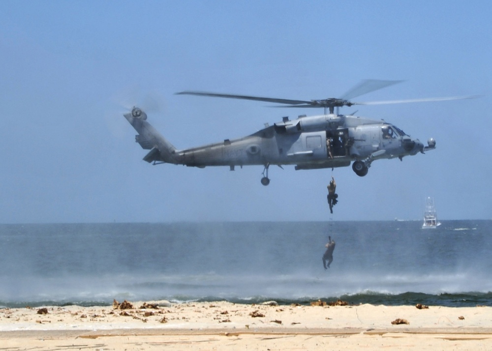 Navy SEALs climb a SH-60 Sea Hawk ladder
