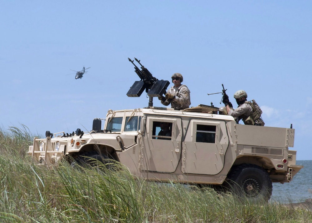 US Navy SEALs ride in special warfare humvee