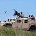 US Navy SEALs ride in special warfare humvee