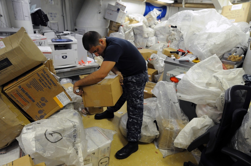 USS George H.W. Bush sailor sorts mail