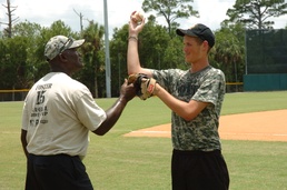 Foster, 1977 MVP, assists Khan with drills
