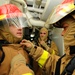 USS Bataan sailors help each dress during drill