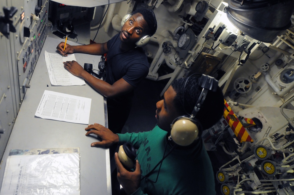 USS George H.W. Bush sailors in catapult room