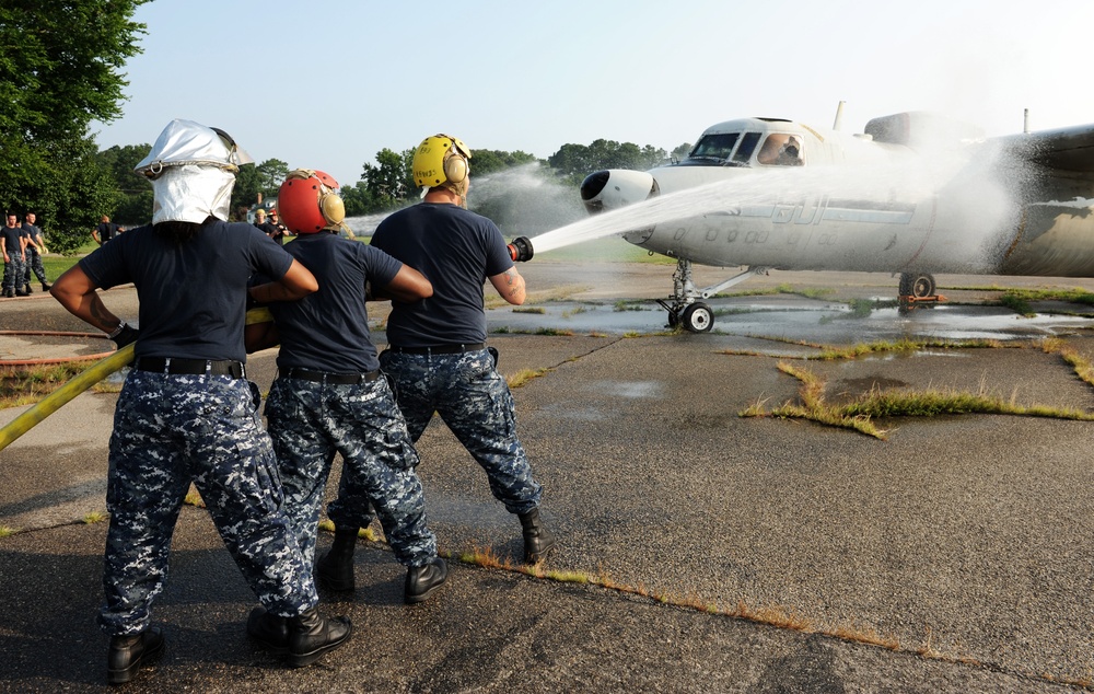 USS Harry S. Truman sailors spray down E2-C Hawkeye