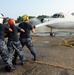 USS Harry S. Truman sailors spray down E2-C Hawkeye