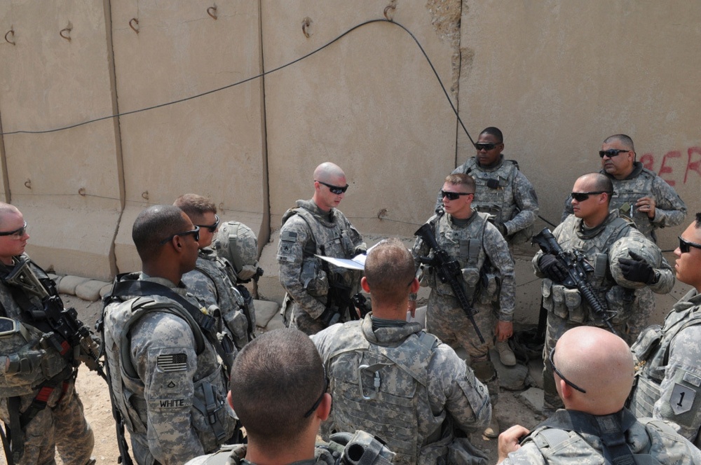 1st Battalion, 7th Field Artillery Regiment Soldiers prepare for a patrol with 1st Federal Police Division counterparts