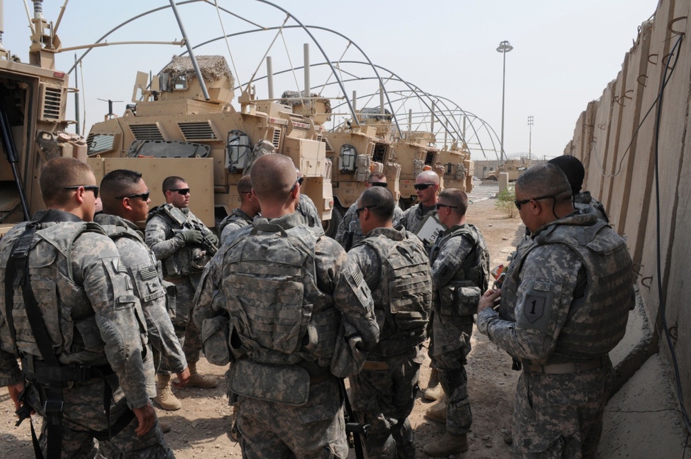 1st Battalion, 7th Field Artillery Regiment Soldiers prepare for a patrol with 1st Federal Police Division counterparts