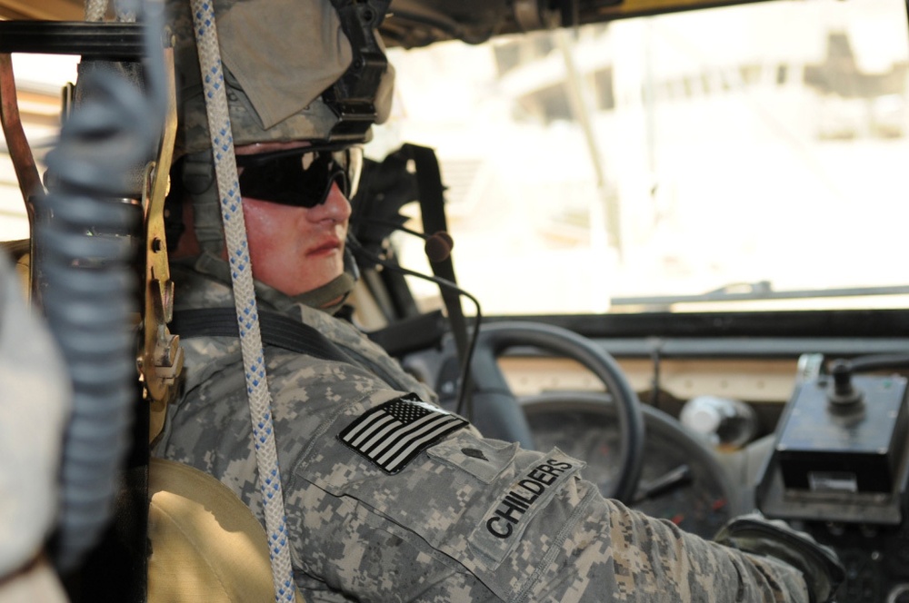 1st Battalion, 7th Field Artillery Regiment Soldiers prepare for a patrol with 1st Federal Police Division counterparts