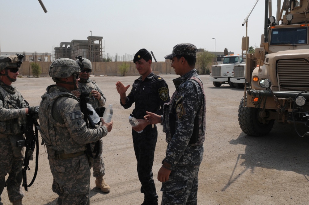 1st Battalion, 7th Field Artillery Regiment Soldiers prepare for a patrol with 1st Federal Police Division counterparts