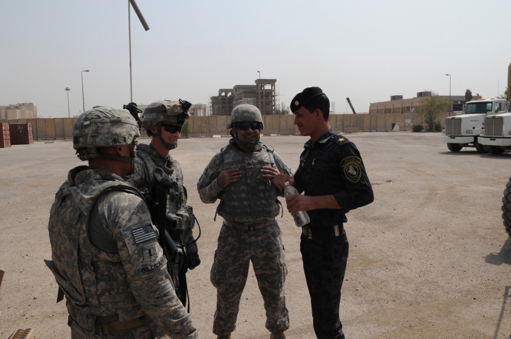 1st Battalion, 7th Field Artillery Regiment Soldiers prepare for a patrol with 1st Federal Police Division counterparts