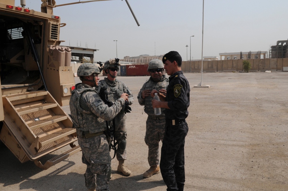 1st Battalion, 7th Field Artillery Regiment Soldiers prepare for a patrol with 1st Federal Police Division counterparts