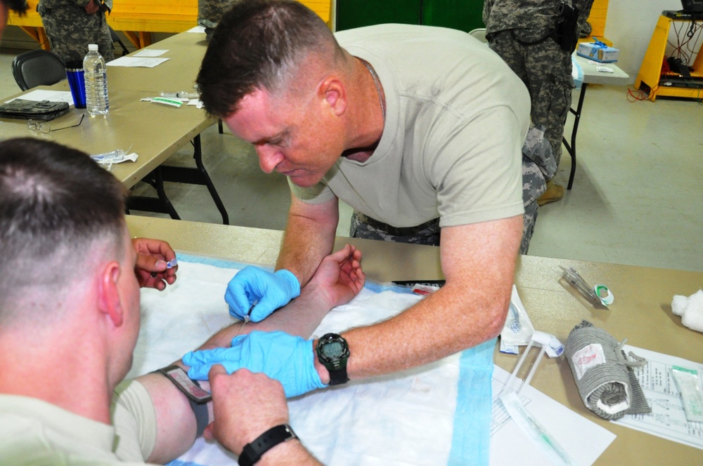 Soldiers with 1st Battalion, 63rd Armor Regiment, maintain proficiency in intravenous aid