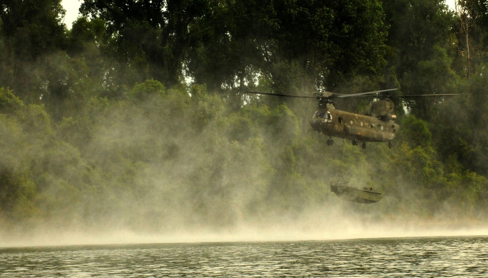 A CH-47 carries 50 boat for the 652nd Engineer Company’s bridge