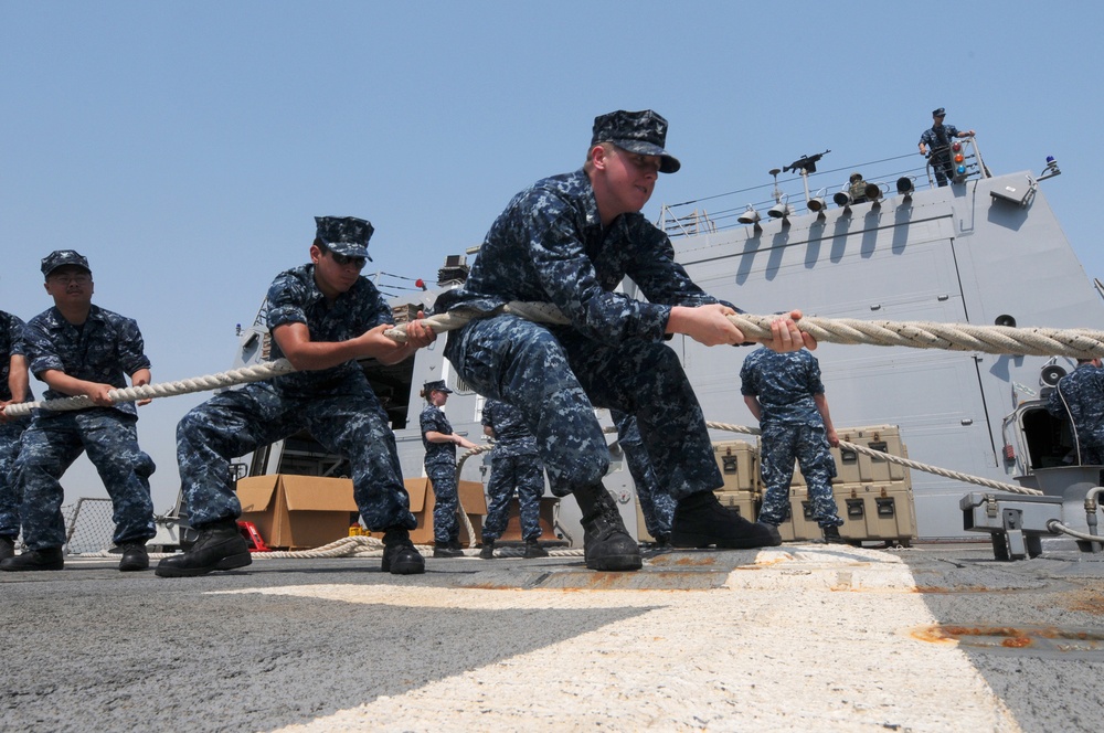 USS Truxton sailors heave a line
