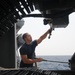 USS Mitscher sailor cleans machine gun