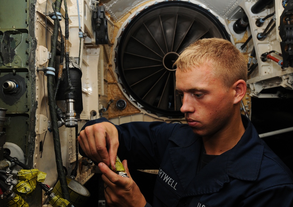 USS George H.W. Bush sailor conducts  F/A-18E Super Hornet maintenance