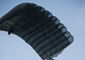 Parachutes over paradise: Force Recon Marines, SEALs, Army and Air Force paratroopers glide over Marine Corps Base Hawaii