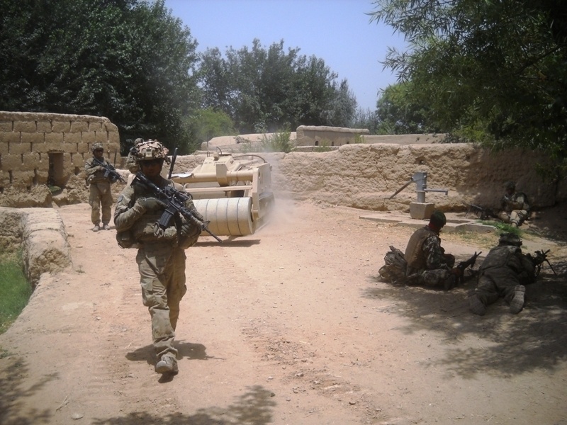 Doking mine-clearance vehicle patrols alongside Spartan soldiers