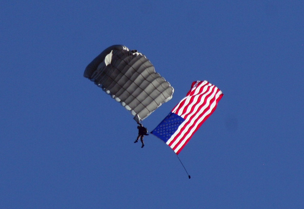 Parachutists deliver American flag for Rodeo opening ceremony