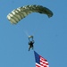 Parachutists deliver American flag for Rodeo opening ceremony