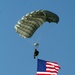 Parachutists deliver American flag for Rodeo opening ceremony