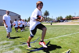 Pendleton children play with the pros at free football camp