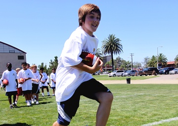 Pendleton children play with the pros at free football camp