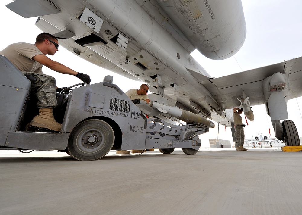 Airmen deployed to Afghanistan load ammo onto A-10’s for missions