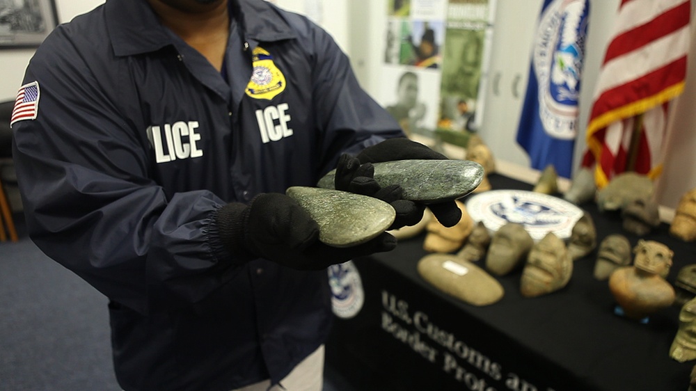 ICE Agent holds ancient tools from the Dominican Republic