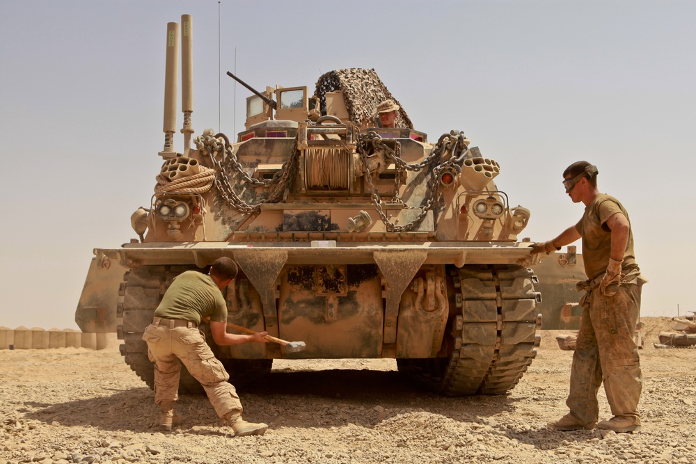 Alpha Company tank mechanics maintain 70–ton armored beasts