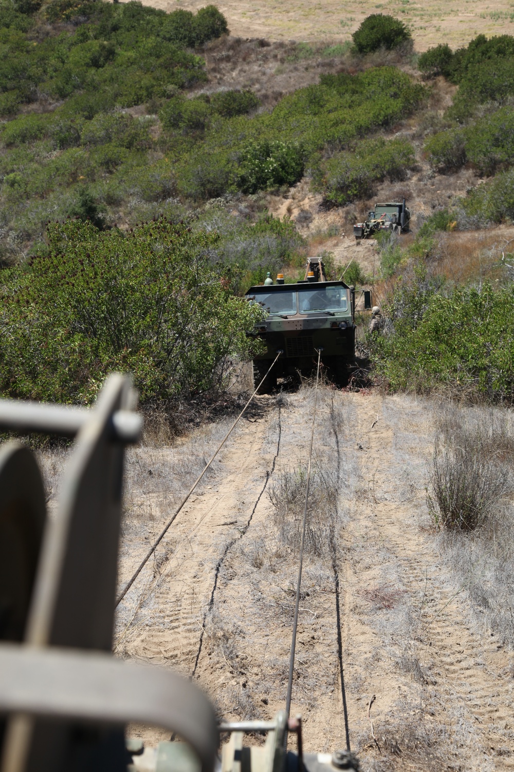 Chain gang: Wreckers train to recover vehicles in desert terrain