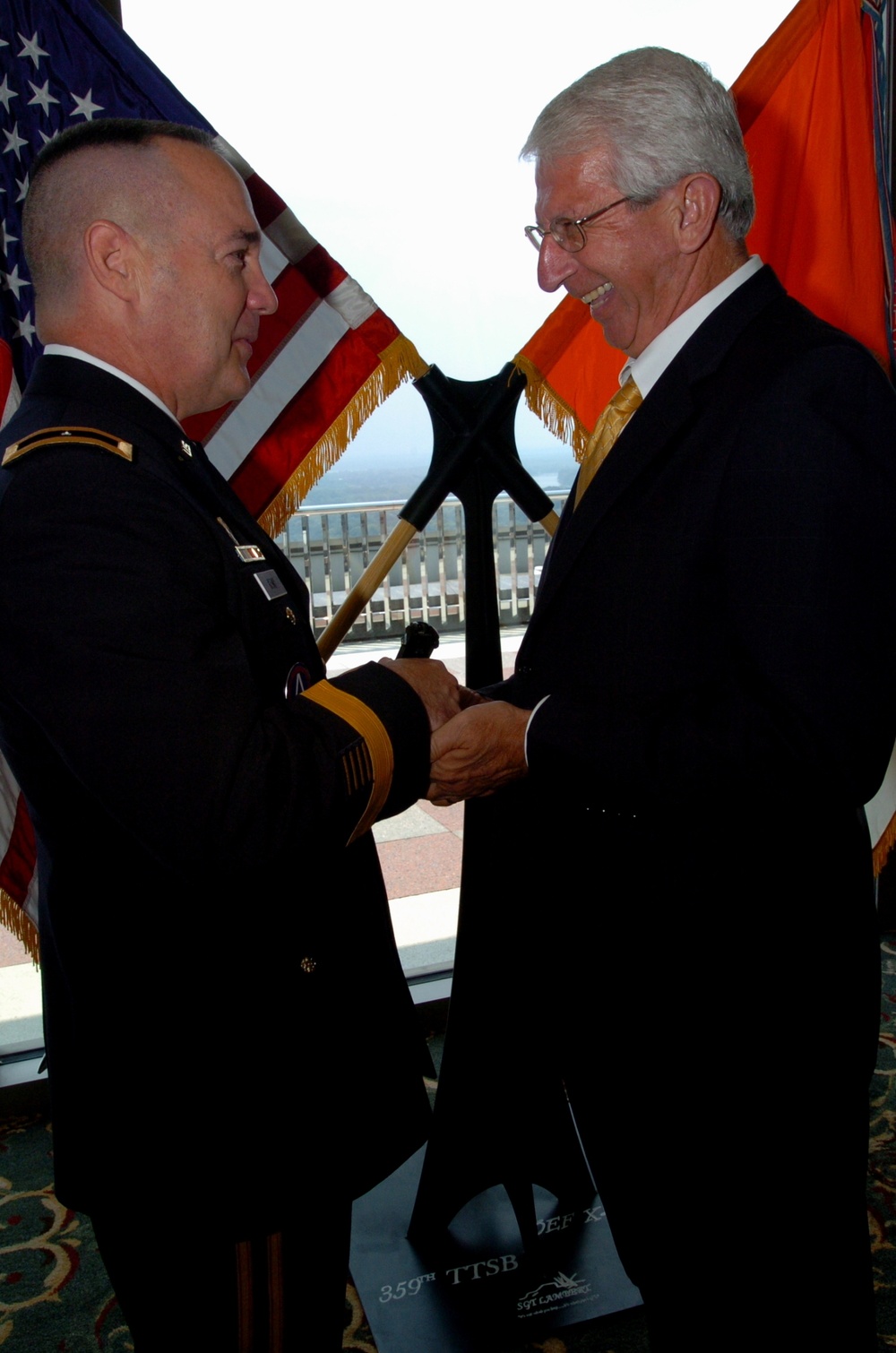 Retired Air Force major presents general officer pistol during ceremony