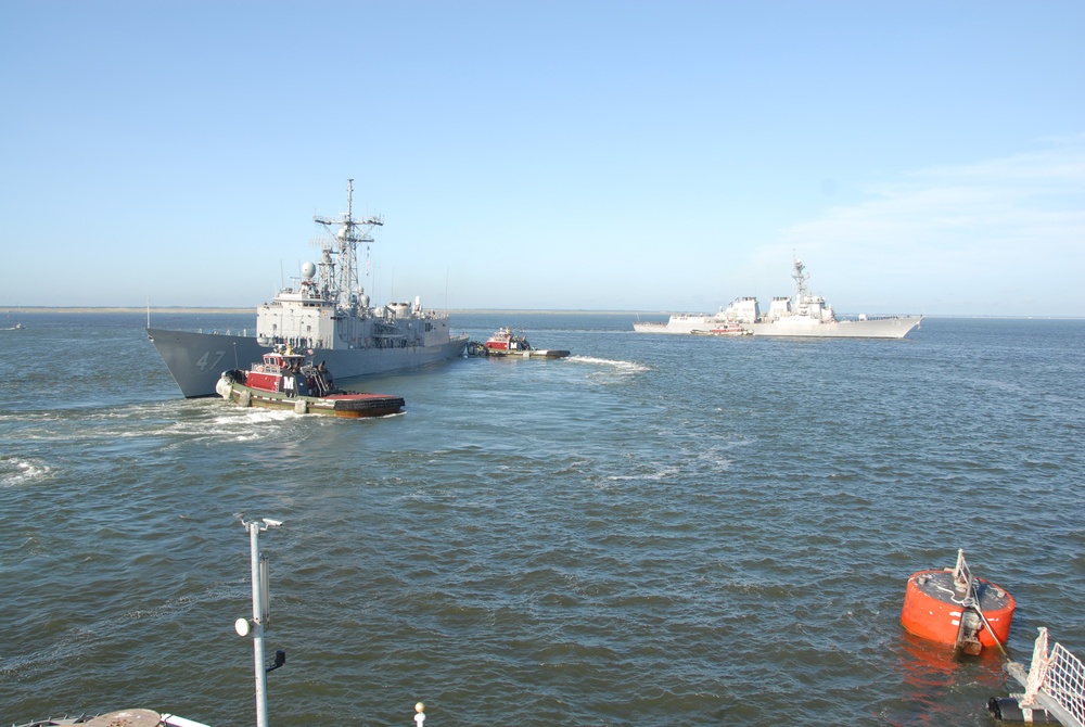 The Arleigh Burke-class guided-missile destroyer  USS Oscar Austin (DDG 79) and the guided-missile frigate USS Nicholas (FFG 47) depart Naval Station Norfolk in advance of Hurricane Irene