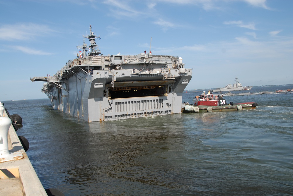 The amphibious assault ship USS Wasp (LHD 1) departs Naval Station Norfolk in advance of Hurricane Irene