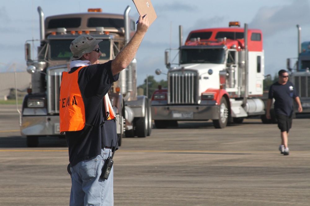 FEMA worker directs relief supply vehicles