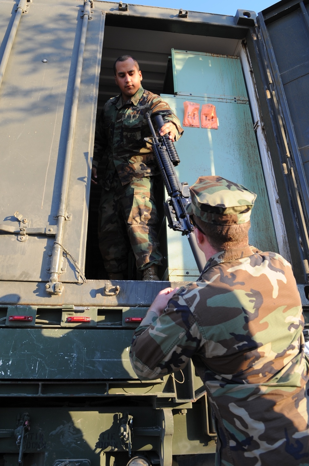 Seabee issuing a grenade launcher