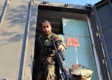 Seabee issuing a grenade launcher